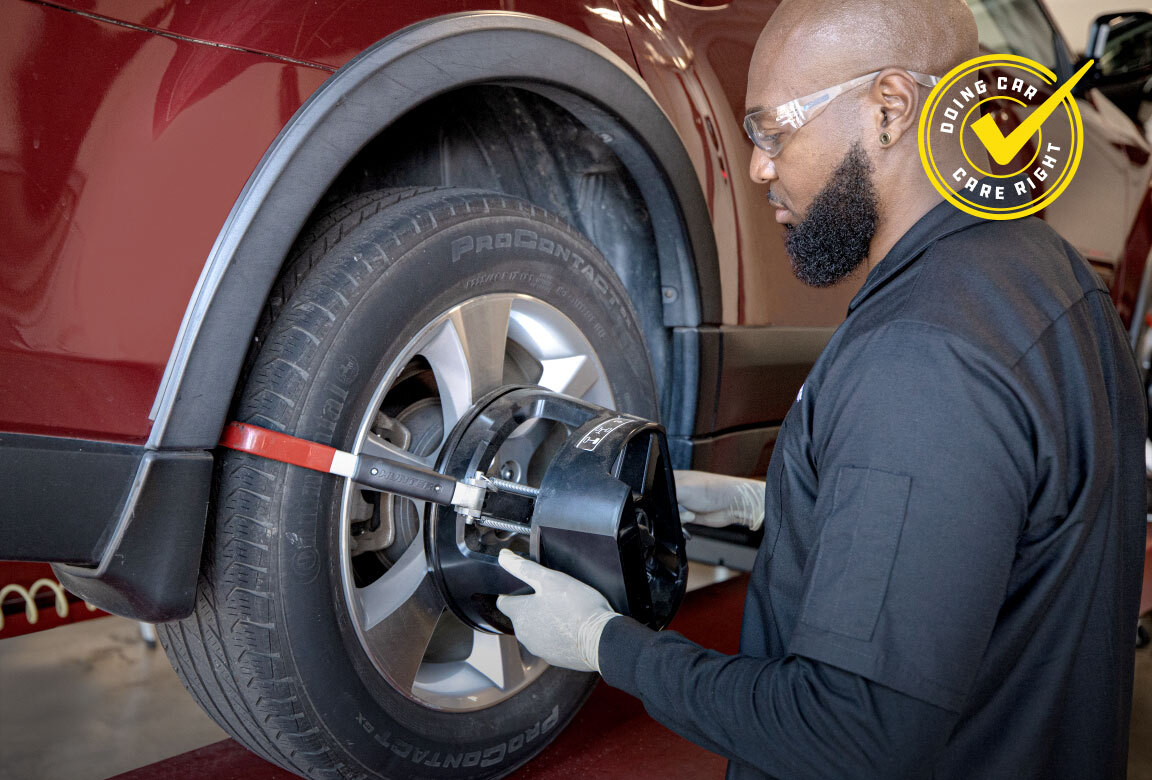 Wheel alignment being performed on a vehicle at a Meineke service bay